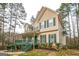 View of a charming two-story home with a welcoming front porch and mature trees in the background at 12 Paces Lakes Overlook, Dallas, GA 30157