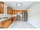 Well-lit kitchen featuring stainless steel appliances, light countertops, and wooden cabinetry at 12 Paces Lakes Overlook, Dallas, GA 30157