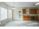 Eat-in kitchen featuring tile floors, wood cabinets and ample sunlight at 12 Paces Lakes Overlook, Dallas, GA 30157