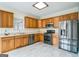Well-lit kitchen featuring stainless steel appliances, light countertops, and wooden cabinetry at 12 Paces Lakes Overlook, Dallas, GA 30157