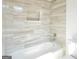 Bathroom shower-tub combo features stylish neutral tone tile surround and a shower niche at 4604 Mossey Dr, Stonecrest, GA 30038