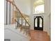 Grand foyer with hardwood floors, ornate iron door, and soaring two-story window at 4604 Mossey Dr, Stonecrest, GA 30038