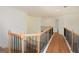 Open hallway with wood floors and iron railing offers views to other parts of the home at 4604 Mossey Dr, Stonecrest, GA 30038