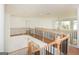 Second floor open hallway with wood floors and iron railing at 4604 Mossey Dr, Stonecrest, GA 30038