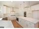 Spacious kitchen features an island, stainless appliances, quartz countertops, and white cabinets at 4604 Mossey Dr, Stonecrest, GA 30038
