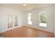 Bright room with hardwood floors, french doors, and two windows offers a welcoming space at 4604 Mossey Dr, Stonecrest, GA 30038