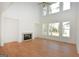 Bright living room featuring a fireplace, large windows, and hardwood floors at 4604 Mossey Dr, Stonecrest, GA 30038