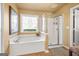 Bright bathroom with a soaking tub and a separate glass enclosed shower at 4770 Shiloh Springs Rd, Cumming, GA 30040