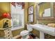 Well-lit powder room with pedestal sink and stylish decor at 4770 Shiloh Springs Rd, Cumming, GA 30040