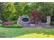 Elegant community entrance featuring stone signage and professionally landscaped grounds at 4770 Shiloh Springs Rd, Cumming, GA 30040