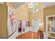 Open foyer with high ceilings, hardwood floors, a transom window and double doors to an office at 4770 Shiloh Springs Rd, Cumming, GA 30040