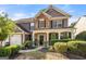 Charming home with stone and siding exterior, covered porch, and lush landscaping at 4770 Shiloh Springs Rd, Cumming, GA 30040