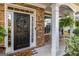 Close-up of the front porch, with stone accents, a welcoming wreath, and hanging plants at 4770 Shiloh Springs Rd, Cumming, GA 30040