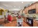 Open kitchen featuring an island, granite countertops, and wood cabinets at 4770 Shiloh Springs Rd, Cumming, GA 30040