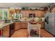 Bright kitchen features stainless steel refrigerator, wood floors, and granite countertops at 4770 Shiloh Springs Rd, Cumming, GA 30040