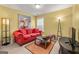 Living room featuring red sofa, a coffee table, and a painting on the wall at 4770 Shiloh Springs Rd, Cumming, GA 30040