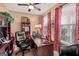 Cozy office space with a dark wood desk, built-in shelving, and patterned curtains at 4770 Shiloh Springs Rd, Cumming, GA 30040
