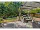 Covered patio featuring outdoor seating and a lush backyard at 4770 Shiloh Springs Rd, Cumming, GA 30040