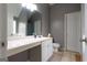 Clean, well-lit bathroom featuring tile floors, a white sink with large mirror, and a toilet at 1632 Zacharys Way, Mcdonough, GA 30253