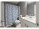 Bathroom featuring a shower with patterned curtain, toilet, and a single sink vanity at 1632 Zacharys Way, Mcdonough, GA 30253