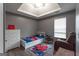 A gray bedroom with a ceiling fan, white trim, laminate floors, and a Spiderman theme at 1632 Zacharys Way, Mcdonough, GA 30253