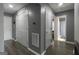 Hallway with gray walls, wood-look floors, and doors leading to rooms and storage at 1632 Zacharys Way, Mcdonough, GA 30253