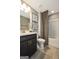 Bathroom with a sleek vanity, framed mirrors, and a shower-tub combination at 2446 Naples St, Hoschton, GA 30548