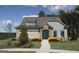 Charming exterior of a single-Gathering home with manicured lawn, stone accents, and welcoming front entrance at 2446 Naples St, Hoschton, GA 30548