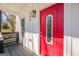Inviting front porch features a bright red front door, modern light fixture, and fresh paint at 200 Adeline Nw Ave, Atlanta, GA 30314