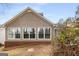 Exterior rear of home featuring brick foundation and natural landscaping at 103 Augusta Dr, Peachtree City, GA 30269