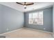 Neutral bedroom with carpet flooring, ceiling fan, and large windows with blinds at 103 Augusta Dr, Peachtree City, GA 30269