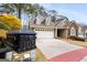 Exterior view of home with a black mailbox in the foreground displaying house number over the long driveway and attached garage at 103 Augusta Dr, Peachtree City, GA 30269