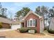 The exterior features brick accents and large windows with black shutters, adding to its appeal at 103 Augusta Dr, Peachtree City, GA 30269