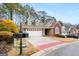 Charming single-story home featuring a two-car garage, brick accents, and manicured landscaping at 103 Augusta Dr, Peachtree City, GA 30269