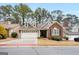 Inviting single-Gathering home boasts a spacious two-car garage, brick accents, and mature landscaping at 103 Augusta Dr, Peachtree City, GA 30269