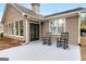 Covered patio featuring exterior access doors and black rocking chairs at 103 Augusta Dr, Peachtree City, GA 30269