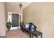 Inviting front porch with a bench, decorative pillows, potted plants, and a black door providing a warm welcome at 103 Augusta Dr, Peachtree City, GA 30269