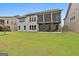 Expansive backyard featuring a screened porch and patio area, perfect for outdoor entertaining at 208 Cottonwood Cir, Peachtree City, GA 30269