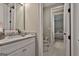 Bathroom with granite countertops, white cabinets, neutral walls, toilet, and a glimpse of the bedroom at 208 Cottonwood Cir, Peachtree City, GA 30269