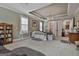 Bright bedroom featuring large windows, a chandelier, with sitting area, and a walk-in shower in view at 208 Cottonwood Cir, Peachtree City, GA 30269