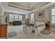 Spacious bedroom with tray ceilings, two chandeliers, plush carpet, and ample natural light at 208 Cottonwood Cir, Peachtree City, GA 30269
