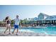 Resort-style pool area with lounge seating and manicured landscaping near a community building at 208 Cottonwood Cir, Peachtree City, GA 30269