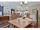 The dining room features a wooden table and chairs with a view into the open kitchen at 208 Cottonwood Cir, Peachtree City, GA 30269