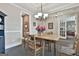 Dining room featuring a wood table and four chairs, view to living room with french doors and hall at 208 Cottonwood Cir, Peachtree City, GA 30269