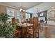 This dining area features a hardwood table, wooden chairs, and an open concept design at 208 Cottonwood Cir, Peachtree City, GA 30269