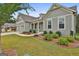 Attractive exterior view with a well-maintained lawn, lush shrubbery, and pleasing architectural details at 208 Cottonwood Cir, Peachtree City, GA 30269