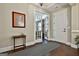 Beautiful foyer featuring hardwood floors, a stylish rug, and view to the living room through french doors at 208 Cottonwood Cir, Peachtree City, GA 30269