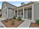 Inviting front entrance with landscaped garden beds, a concrete walkway, and gray siding at 208 Cottonwood Cir, Peachtree City, GA 30269