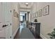 Hallway featuring wood floors, gray and white braided rug, gray bookshelf, and art on the walls at 208 Cottonwood Cir, Peachtree City, GA 30269