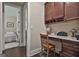 Home office with dark wood built-ins, granite counters, an adjacent bedroom, and light hardwood floors at 208 Cottonwood Cir, Peachtree City, GA 30269